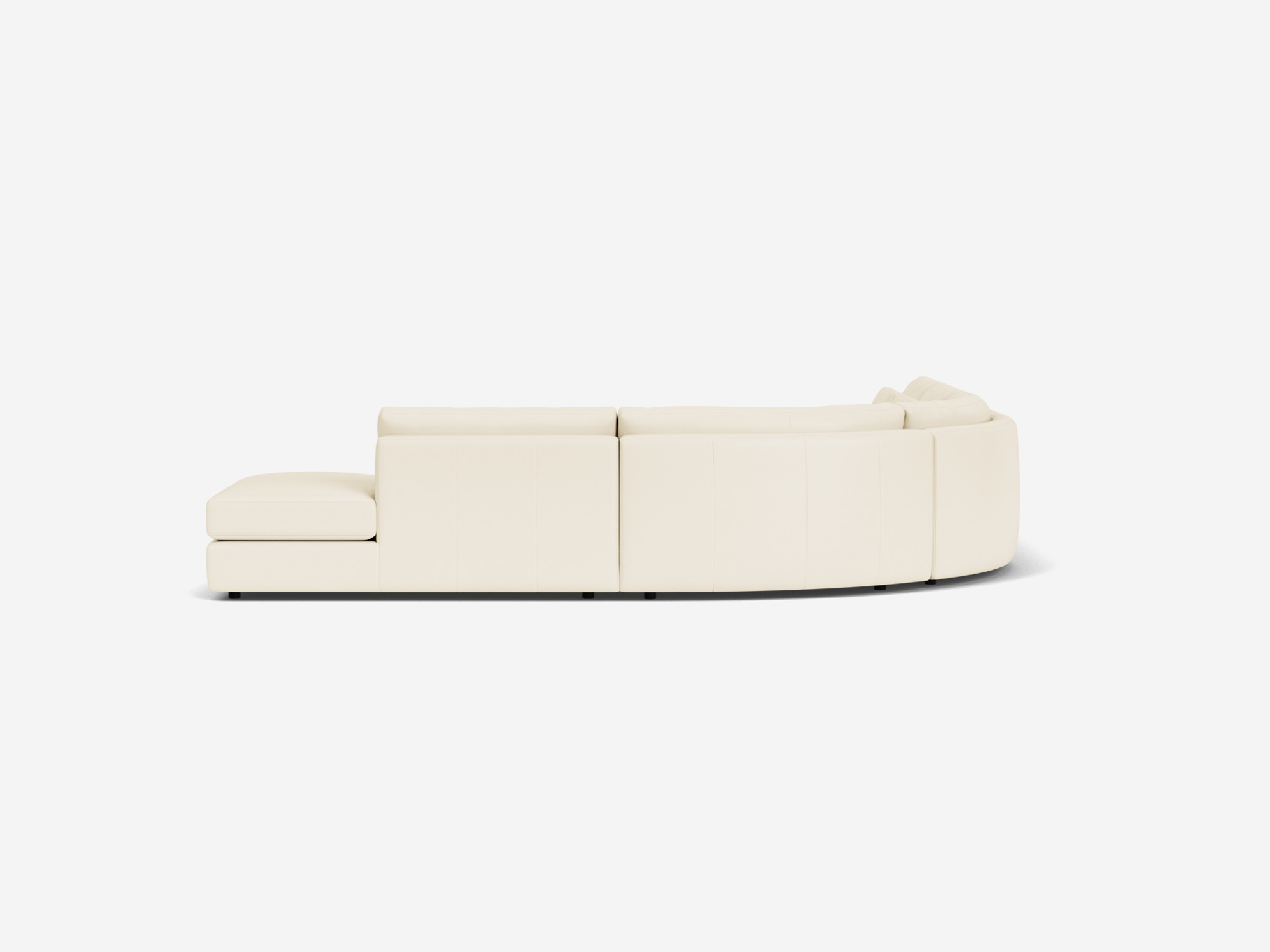 Right side view of white curved leather sectional sofa with right hand chaise